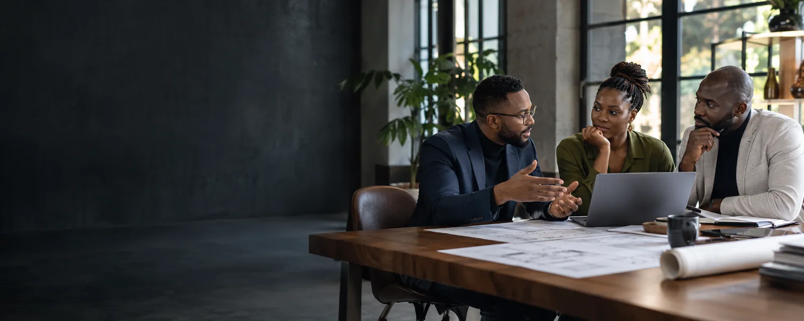 Black African technology consultant discussing workflows with business owners